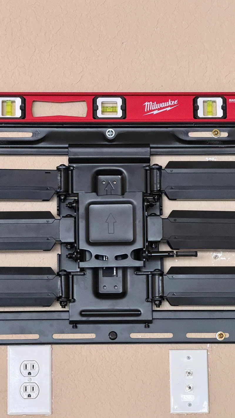 Spirit level on the wall bracket above existing connection plates