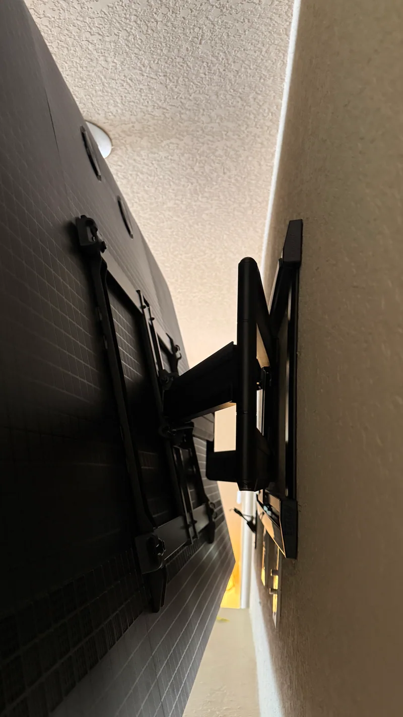 Close side view of the articulated bracket behind the TV